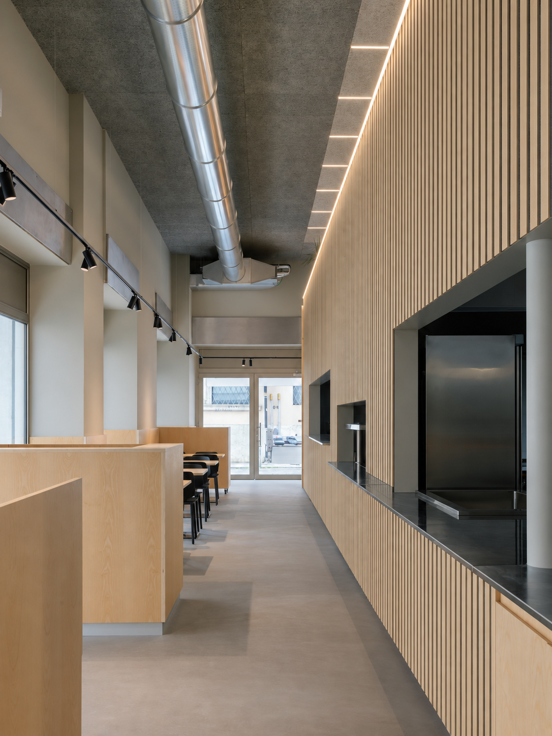 White oak acoustic slat panels along a cafe feature wall